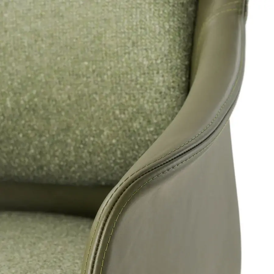 Superior Turri Echo armchair offers welcoming seating upholstered in muted green leather with curved silhouette and stitching detail