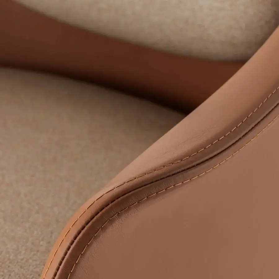 Distinctive Turri Echo armchair crafted in light brown leather with textured beige fabric seating and detailed stitching