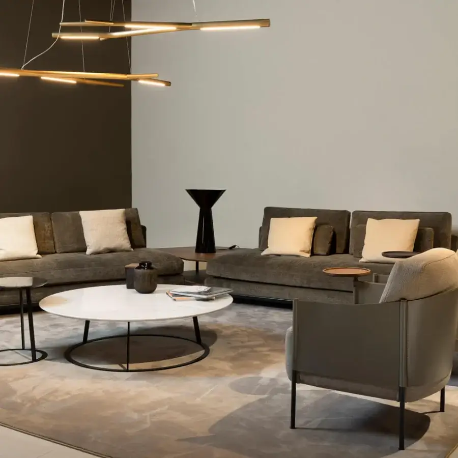Distinguished Horm Aira suspension lamp with a gold painted brass frame and interconnected linear elements casting a warm glow