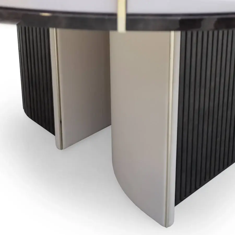 Innovative Turri Eclipse table with a glossy dark top, grooved wood and light leather accents with gold details