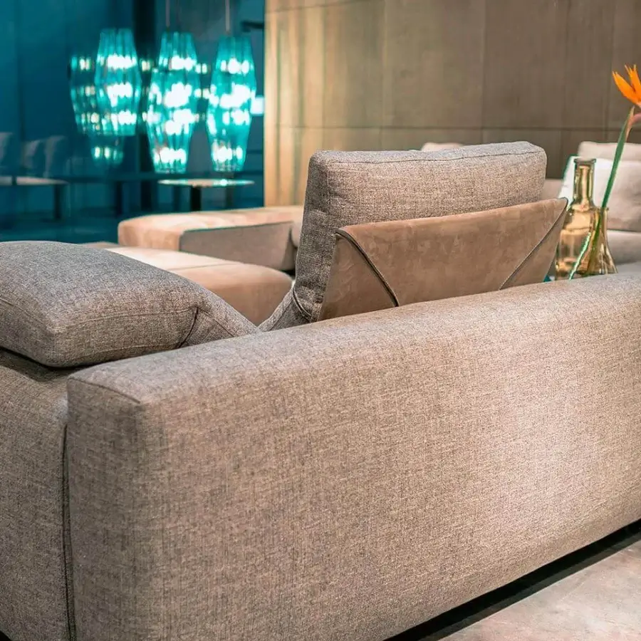 Captivating Arketipo Atlas sectional with light grayish-brown textile upholstery and contrasting brown suede-like pillows in a matte finish