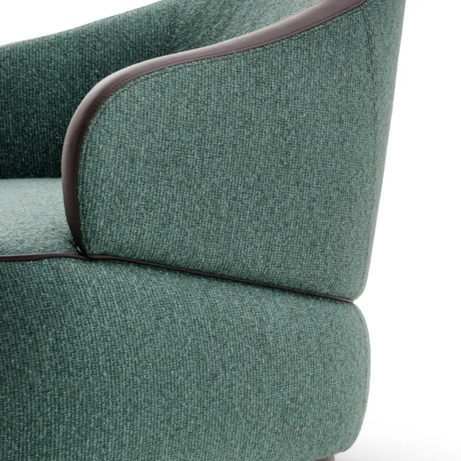 Lavish Turri Bloom lounge chair with graceful lines upholstered in textured green textile and dark brown leather trim