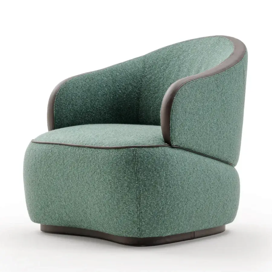 Superior Turri Bloom lounge chair with soft lines upholstered in textured green fabric and rich brown leather trim