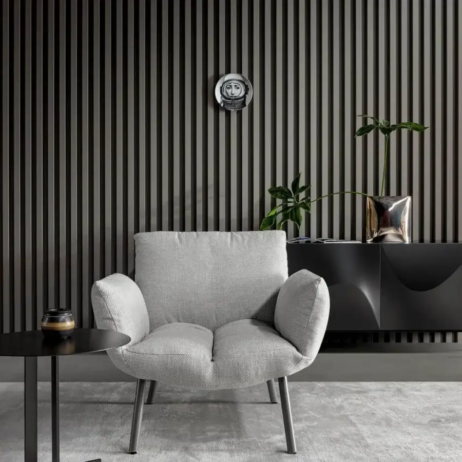 Superior Bonaldo Pil lounge chair with cushion-inspired form upholstered in light gray textile and slender metal legs with matte finish