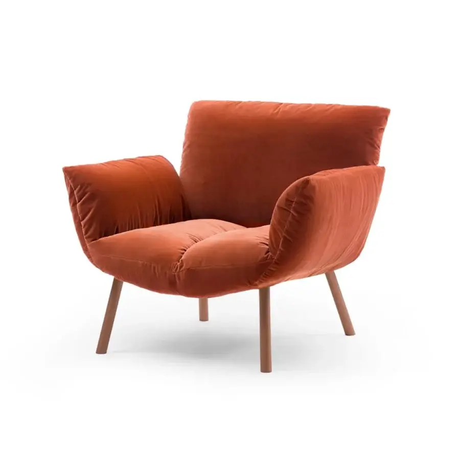 Exceptional Bonaldo Pil lounge chair with enveloping form upholstered in rust-colored textile and slender metal legs with matching finish