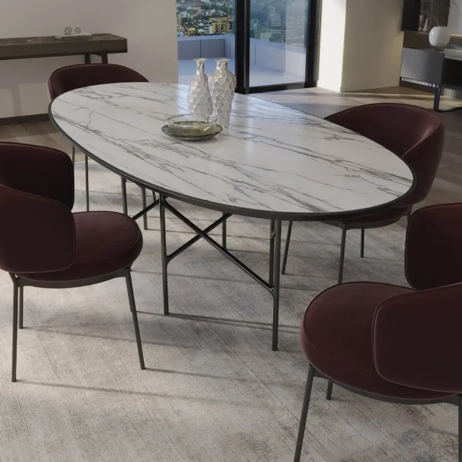 Distinguished Horm Alexander table with oval marble tabletop and dark-toned metal trestle base crafted in Italy