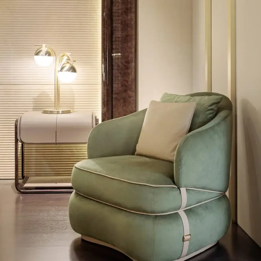 Captivating Turri Bloom lounge chair with light green textile upholstery and a leather accented band built with metallic hardware