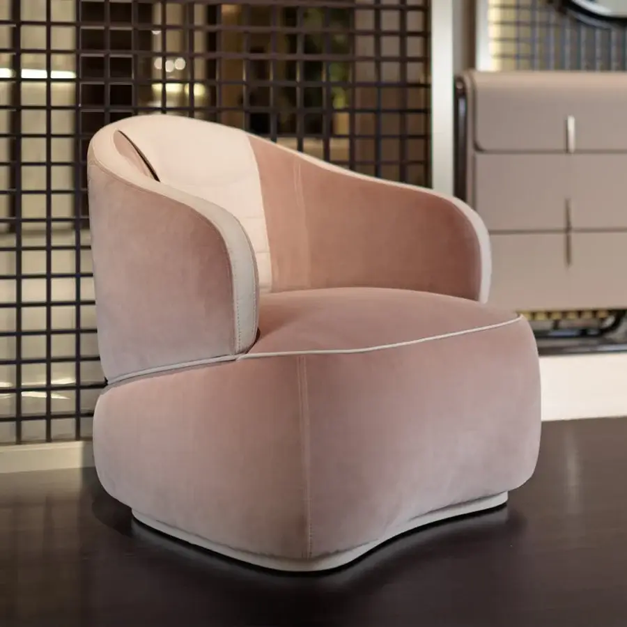 Elegant Turri Bloom lounge chair in pink textile with light beige leather accents and delicate white piping