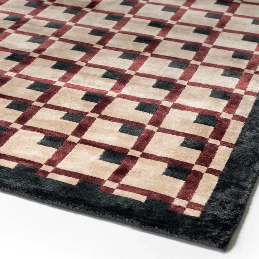 Distinguished Turri Eclipse rug showcases a captivating geometric pattern in burgundy and black with lustrous silk and a matte beige finish