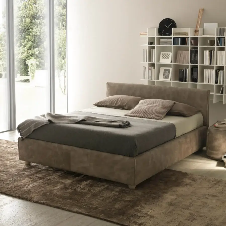 Exceptional Bolzan Letti bed with balanced proportions and soft surfaces wrapped in muted brown textile and crafted with a firwood structure