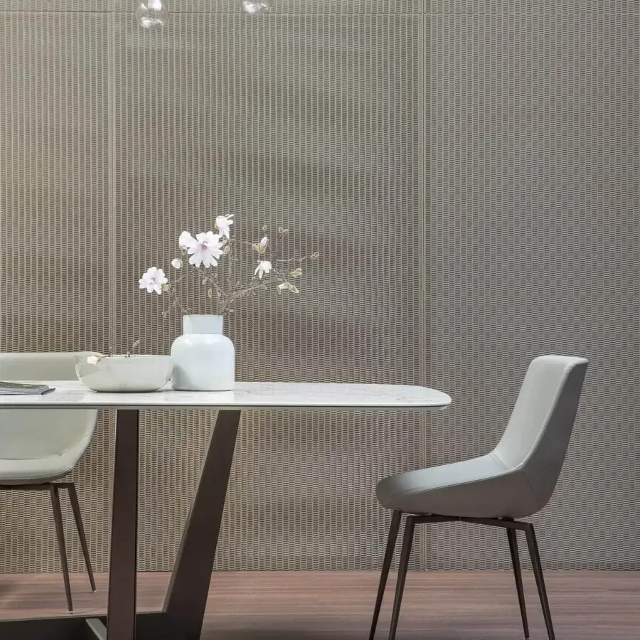 Elegant Bonaldo Artika chair in light gray synthetic leather with matte finish and dark bronze metal legs