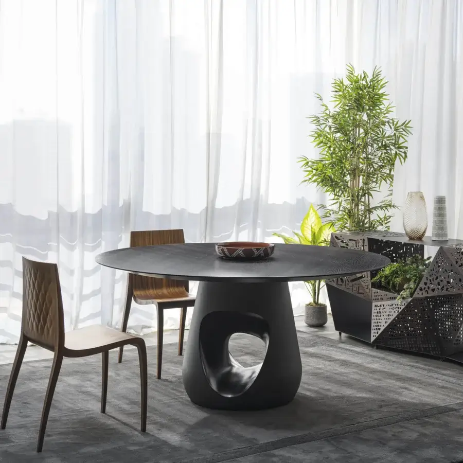 Distinguished Horm Barbara table with a dark-toned wood tabletop and organically shaped matte dark concrete base