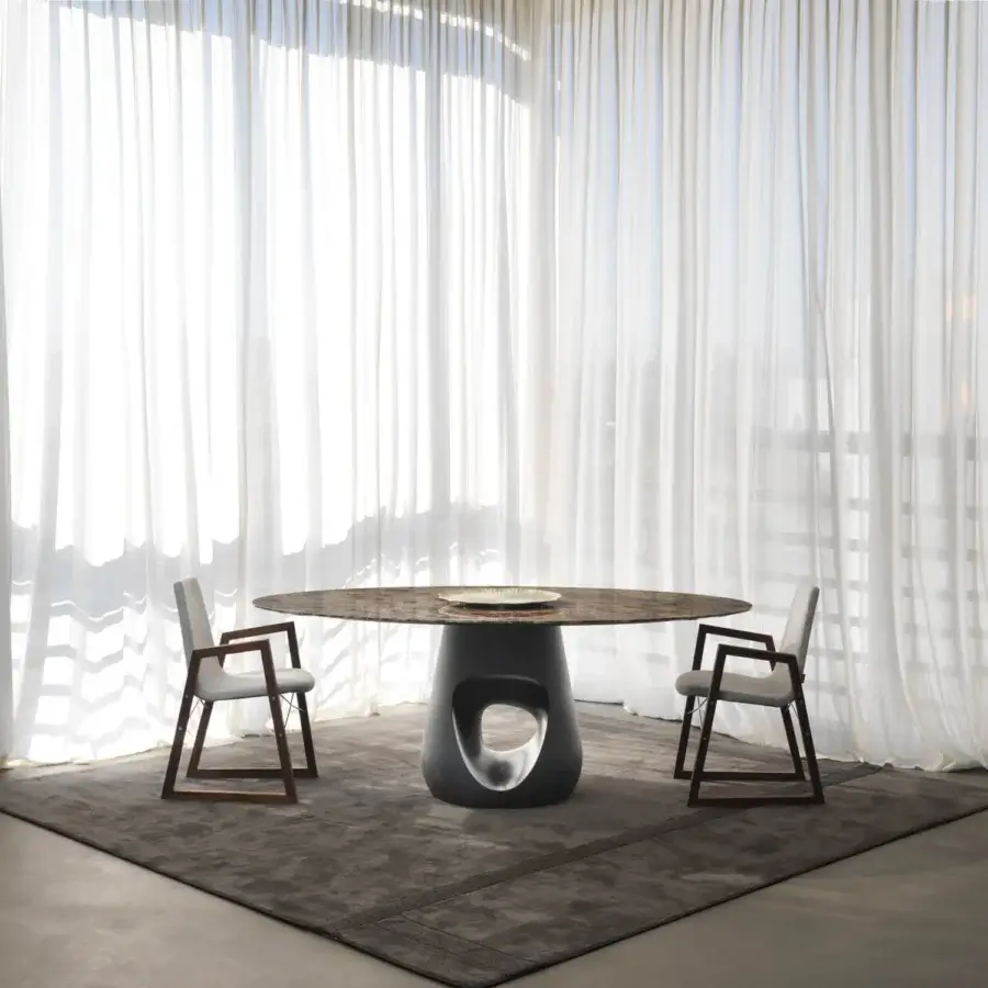 Superior Horm Barbara table with a mottled marble top and sculptural dark gray concrete base crafted in Italy