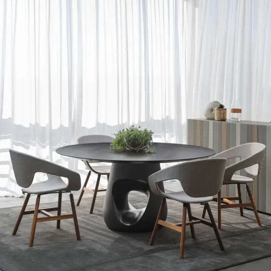 Superior Horm Barbara table with round dark wood top and sculptural concrete base inspired by organic forms