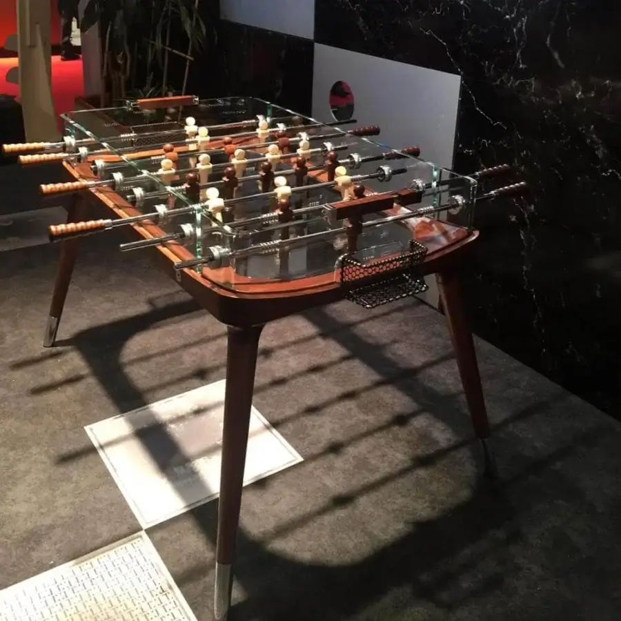Distinguished Teckell 90º Minuto foosball table with a solid molded wood structure and transparent crystal playing field in glossy finish