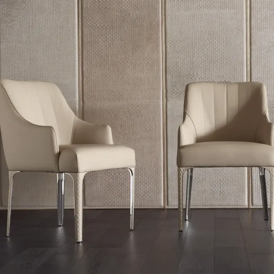 Distinguished Rugiano Arianna armchair upholstered in light beige textile with smooth finish and refined steel legs with matelassé embroidery