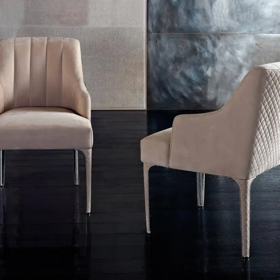 Superior Rugiano Arianna armchair upholstered in light beige textile with refined steel legs and matelassé embroidery
