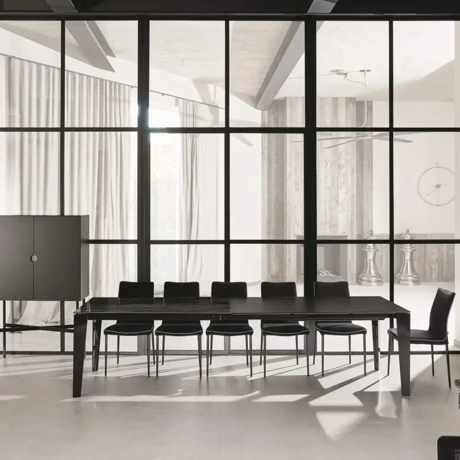 Superior Bontempi Cruz extendable table with dark matte wood finish crafted for versatile design and paired with black seating and slender metal legs