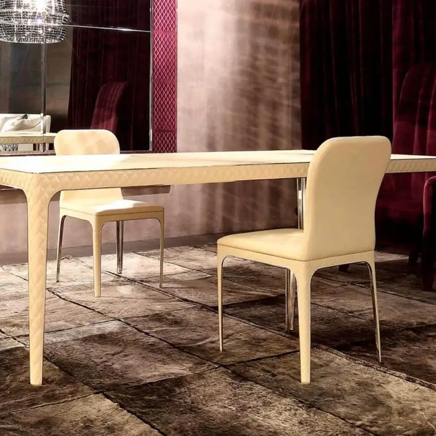 Elegant Rugiano Viviane chair with curved silhouette upholstered in light beige fabric and bronze finished metal legs