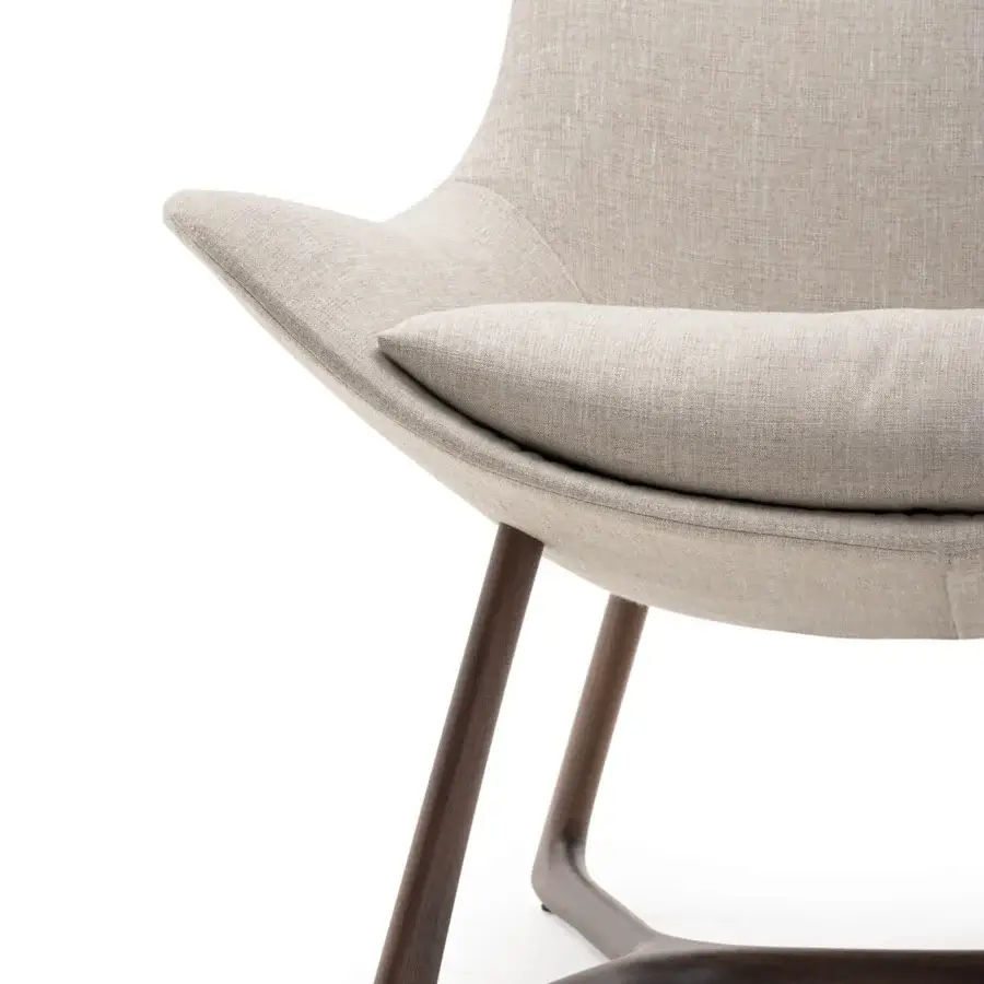 Elegant Turri Harp Lounge Chair with light beige textile upholstery and a solid walnut wood base crafted with angled legs