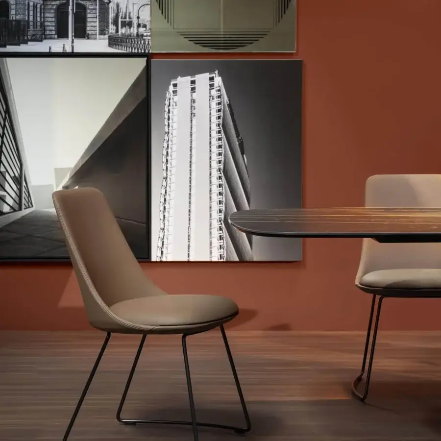 Distinguished Bonaldo Itala chair with soft lines and black metal legs upholstered in light brown synthetic material