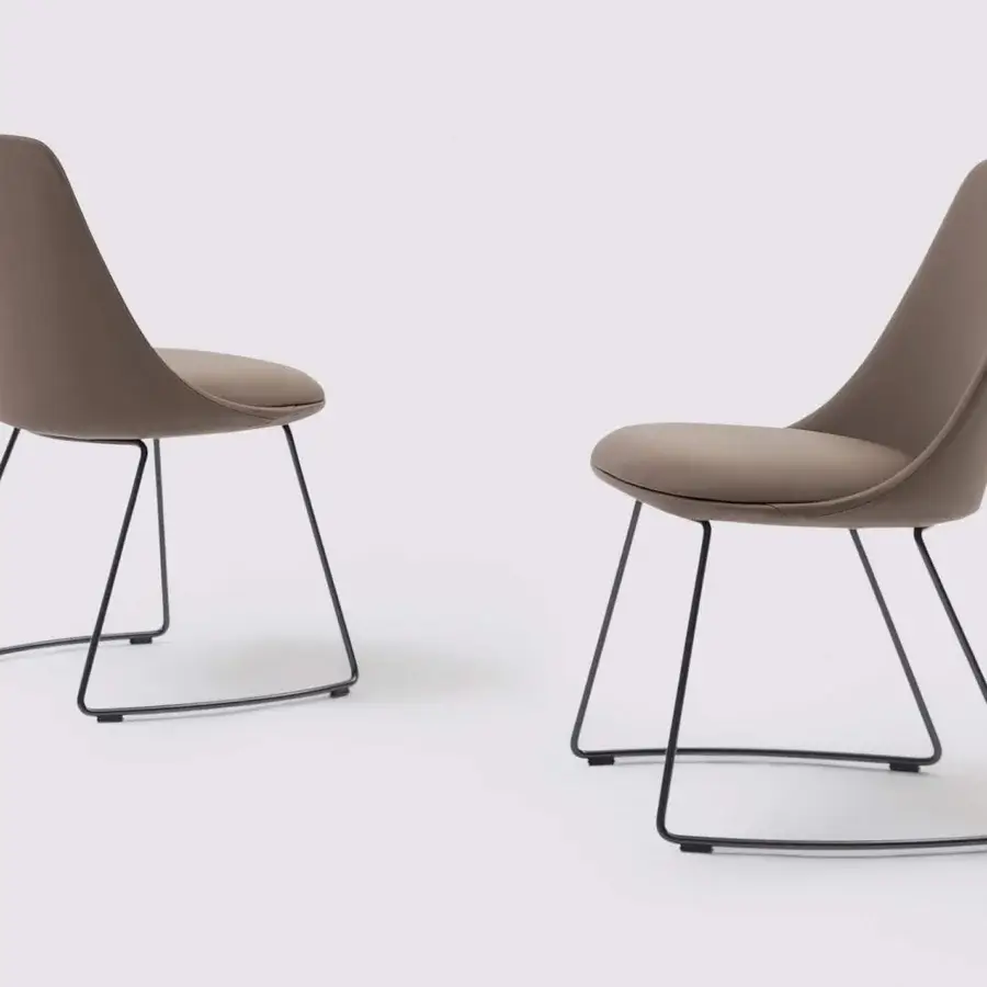 Exclusive Bonaldo Itala chair with romantic lines upholstered in light brown textile and sleek black metal legs