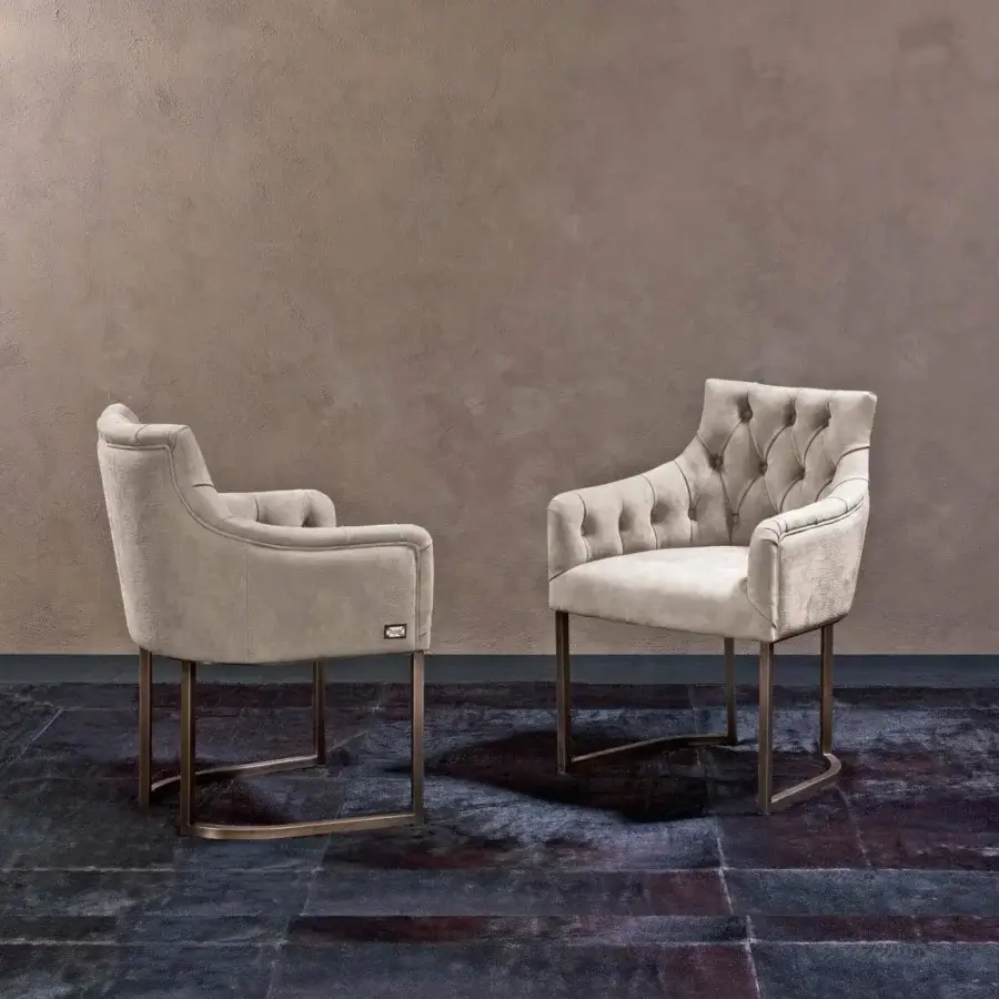 Superior Rugiano Itaca armchair with a high-end metal base and dark upholstery displaying a complex mottled pattern