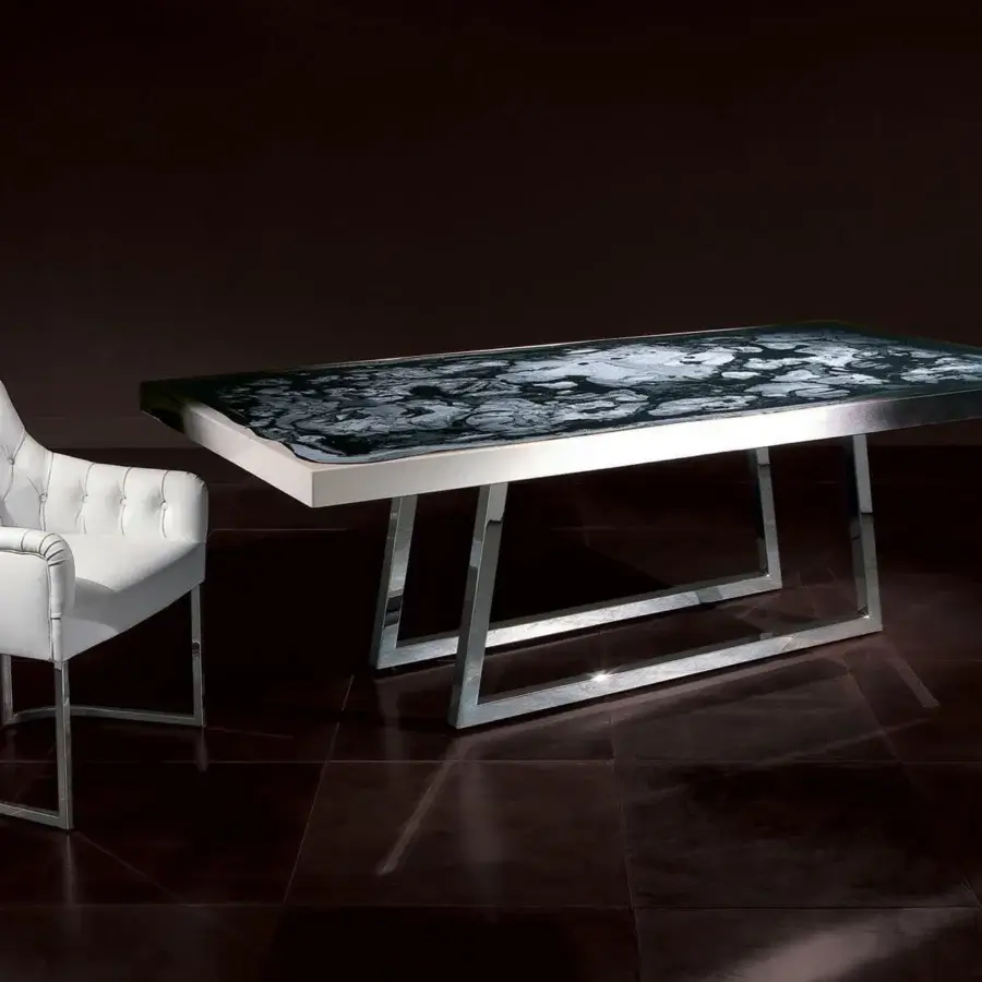Elegant Rugiano Itaca table with grey and white patterned tabletop and glossy reflective metal base