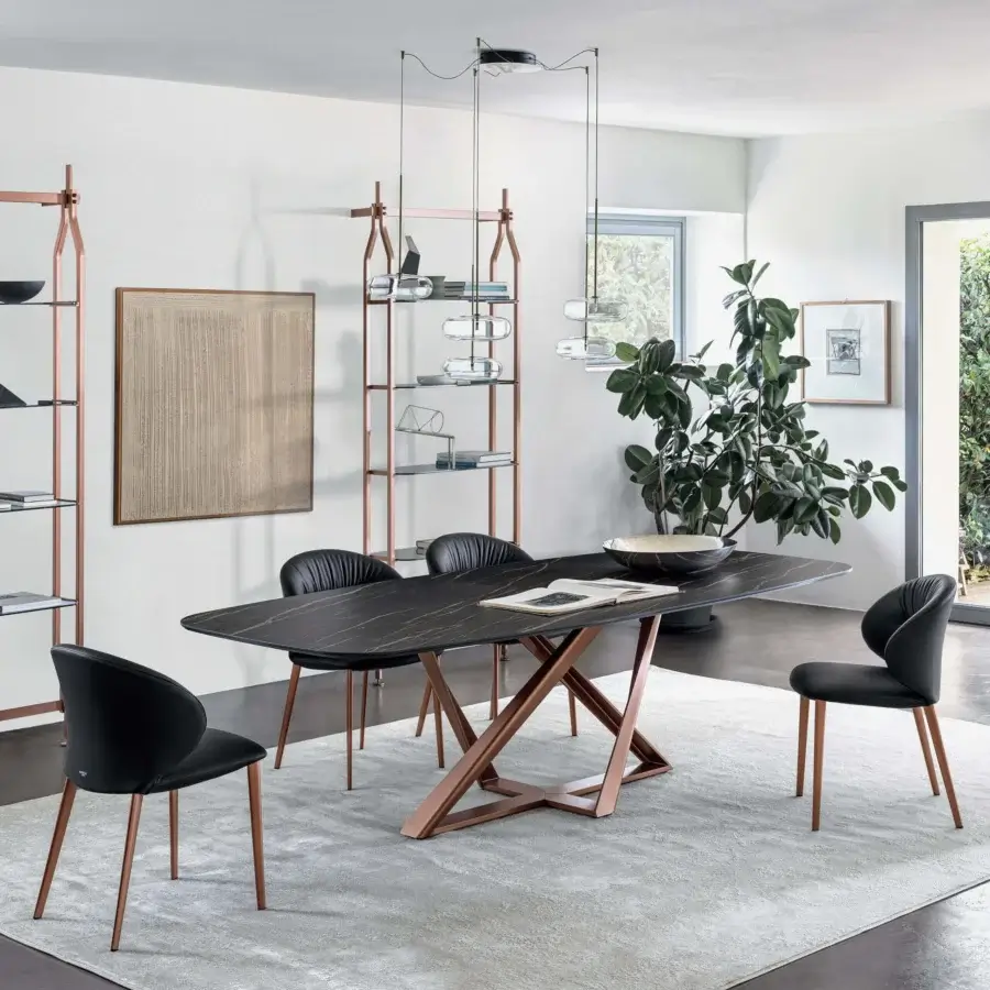 Innovative Bontempi Millennium Barrel table with a dark marble-like top and copper-finished metal X-shaped base