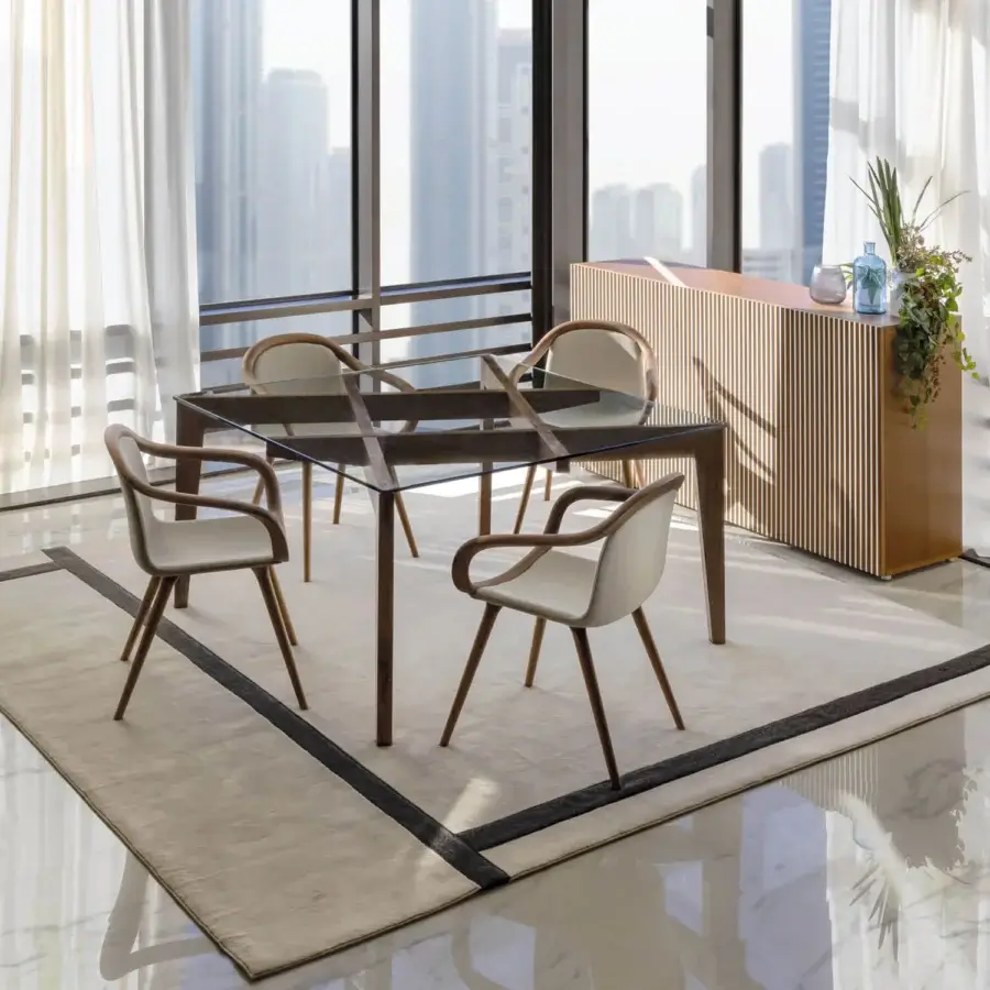 Distinguished Horm Ginevra armchair with curved form and balanced proportions crafted in solid walnut wood with light cream fabric upholstery