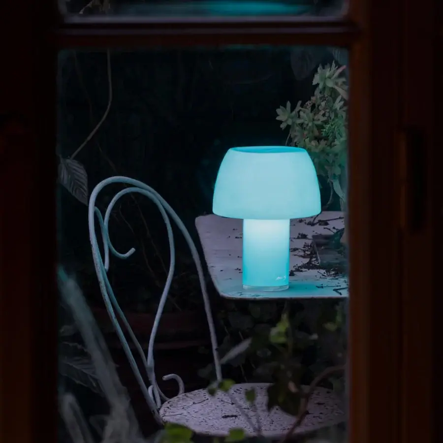 Distinguished Nemo Lorosae lamp evokes sunrise with smooth translucent form glowing in bright modern blue crafted in Italy