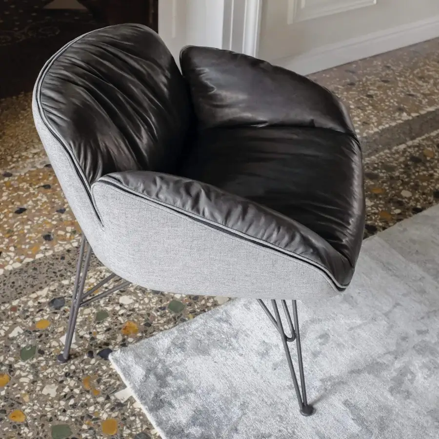 Distinguished Arketipo Juno lounge chair with dark gray synthetic leather and lighter gray textile, crafted in Italy with matte metal feet