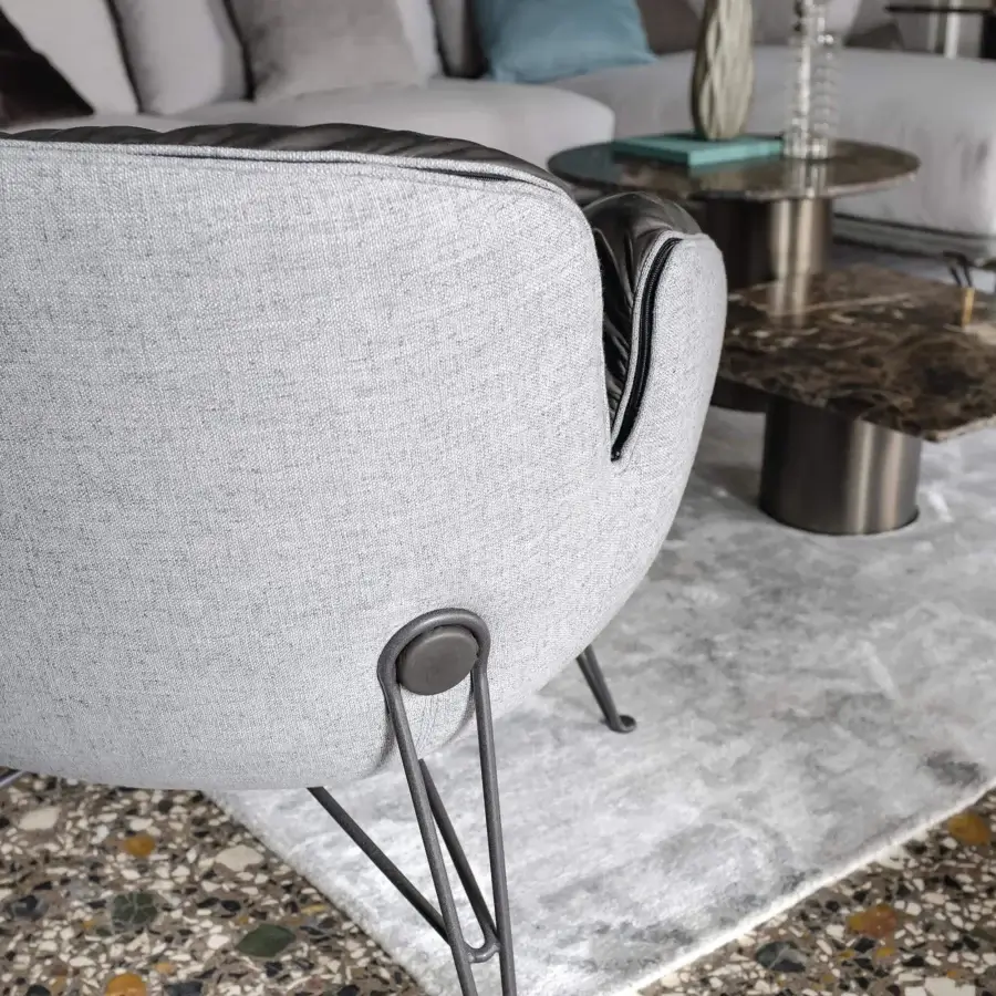 Exceptional Arketipo Juno lounge chair in light gray textile with dark trim and unique three-dimensional metal feet