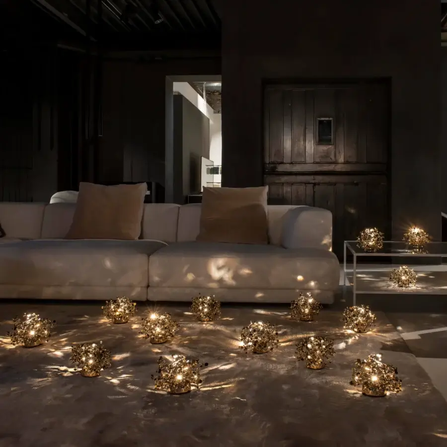 Superior Terzani Argent Mon Bijou lamp crafted in Italy with stainless steel and gold-toned metallic finish casting intricate patterns