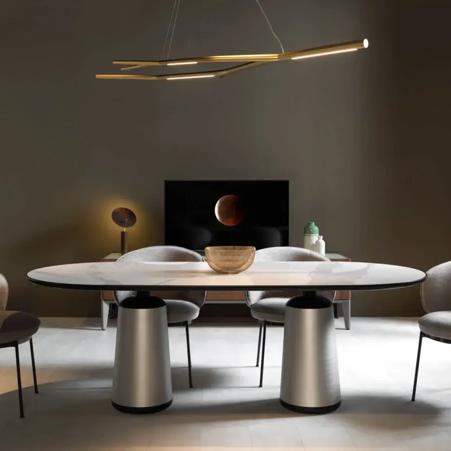 Distinguished Horm Marien table with light gray and white marble tabletop edged in black and brushed silver metal base