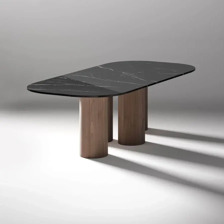Harmonious Horm Marina table with a rounded rectangular black marble top and cylindrical walnut legs