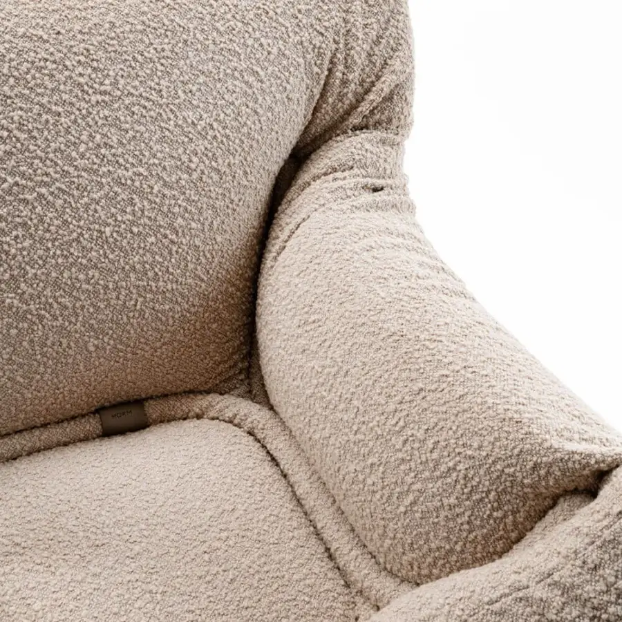 Distinguished Horm Mass Pressure lounge chair crafted from tubular metal compressing segmented foam with light beige premium boucle fabric