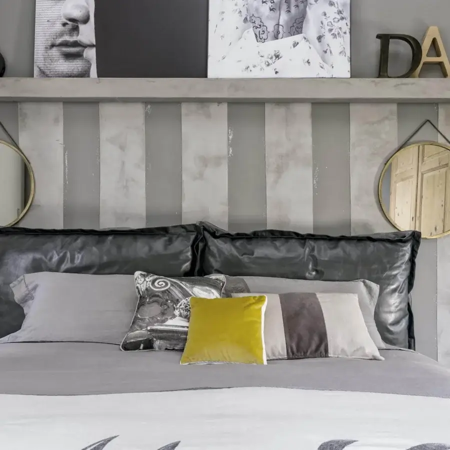 Distinguished Arketipo Auto-Reverse Dream bed crafted in Italy with dark gray upholstery and yellow-brown textile bedding