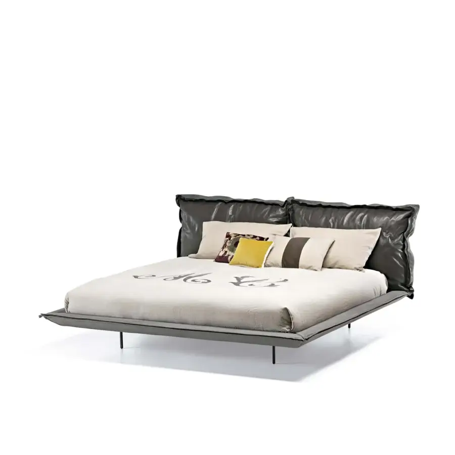 Elegant Arketipo Auto-Reverse Dream bed with a light gray textile frame and glossy dark upholstery exhibiting handcrafted flounces