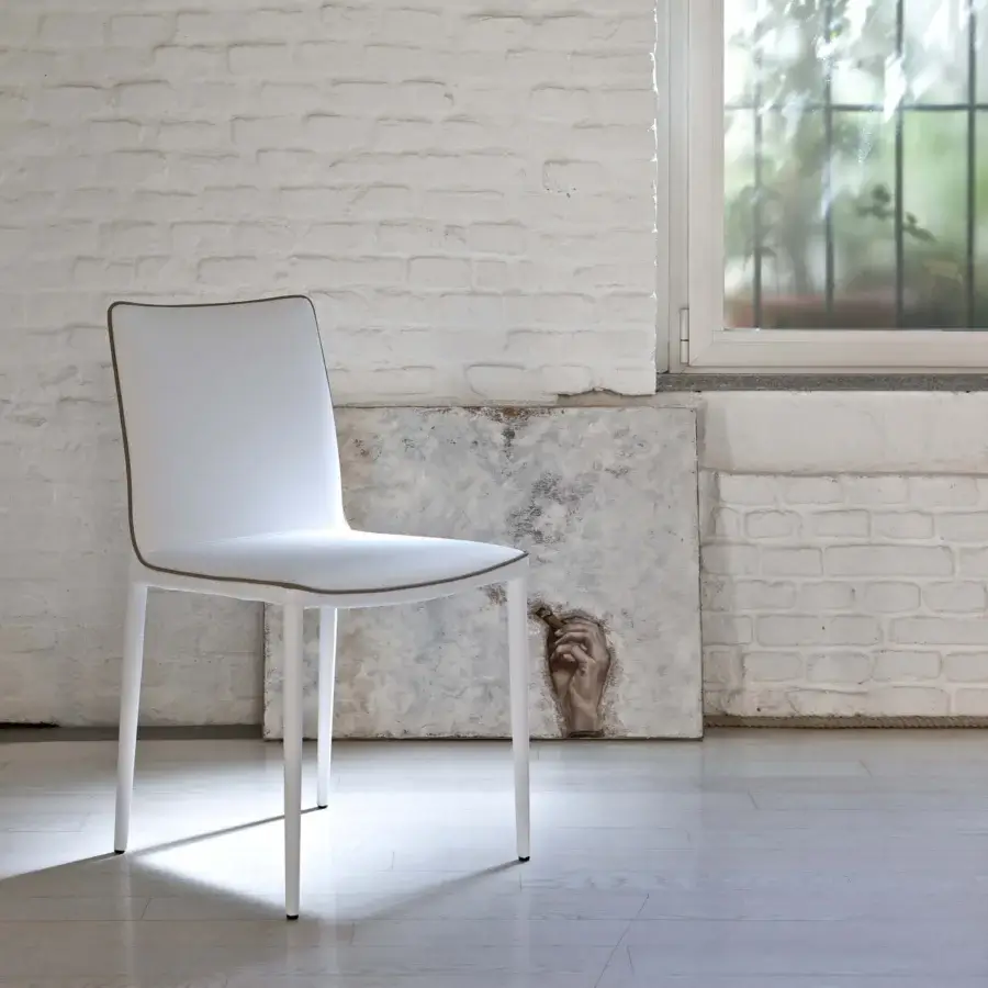 Distinguished Bontempi Nata chair upholstered in smooth white synthetic material with subtle brown piping and sleek metal legs