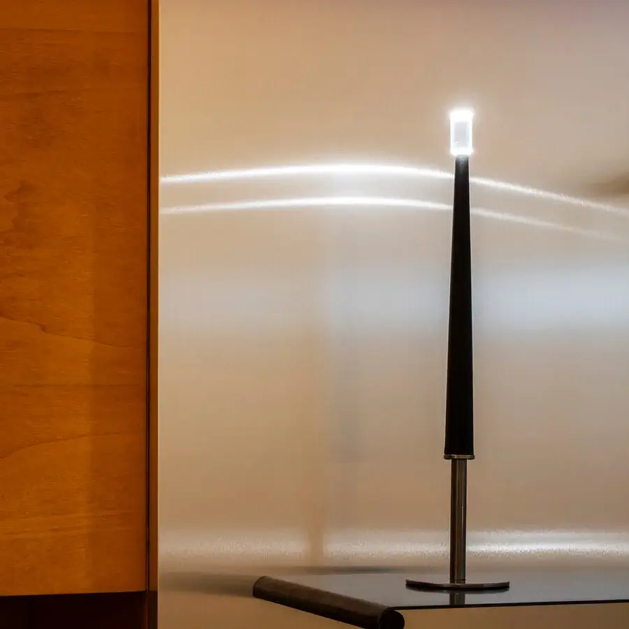 Elegant Nemo Lighting Sorrento table lamp with a slender black aluminum stem and satin metal base, in transparent methacrylate