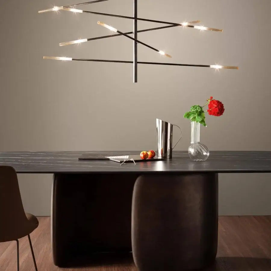 Distinguished Bonaldo Mellow table with soft shapes, a dark stone-like top and deep brown rigid polyurethane pedestal bases