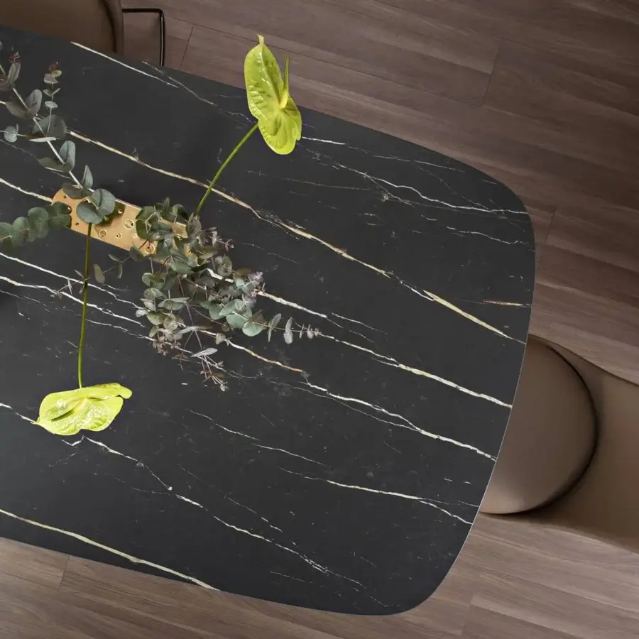 Elegant Bonaldo Mellow table with a shaped top exhibiting white and gold veining in black ceramic and a rigid polyurethane base