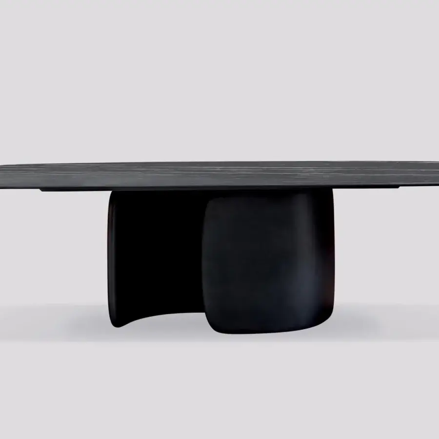 Superior Bonaldo Mellow table with curvilinear shapes, a dark stone-like tabletop exhibiting light striations and a matte finish