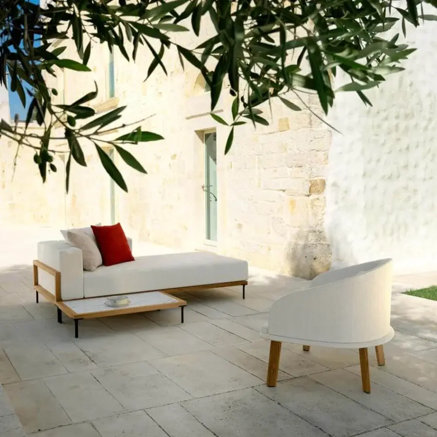 Distinguished Talenti Cleo lounger with light-colored weather-resistant fabric cushions and a matte teak frame