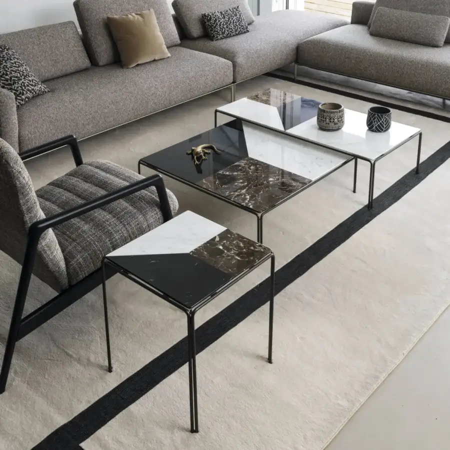 Distinguished Horm Ragtime tables with angular silhouettes and Carrara, Emperador, Marquina marble tops in glossy finish with matte black bronze painted metal bases