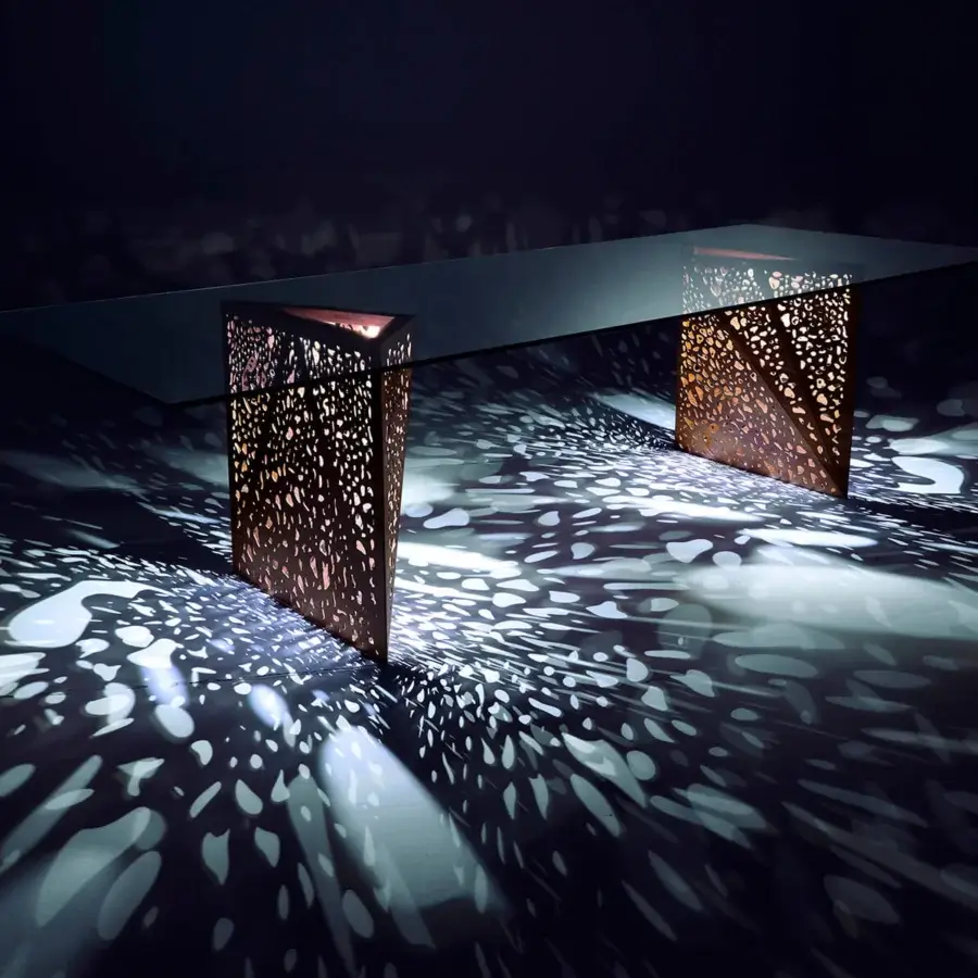 Exceptional Horm Riddled table crafted in Italy with a clear glass top and textured bronze or copper origami-like pedestals built with laser-engraved wood