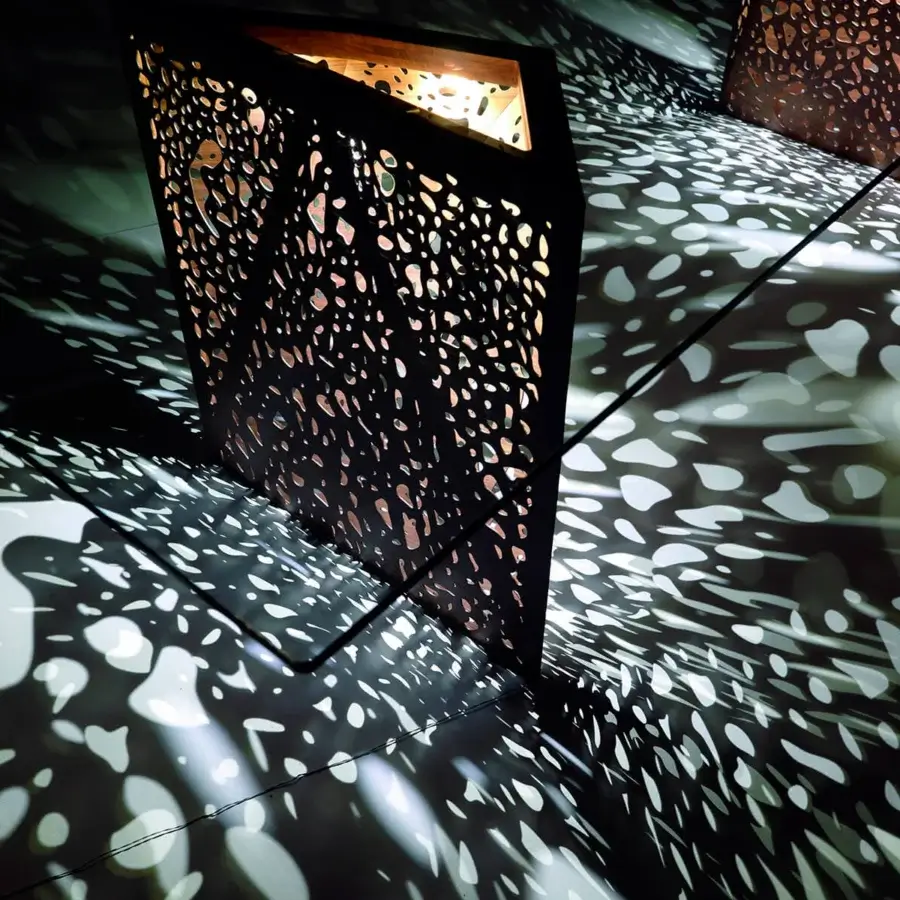 Distinguished Horm Riddled table with laser-engraved wooden legs and cut-out panels in dark tones with a matte finish