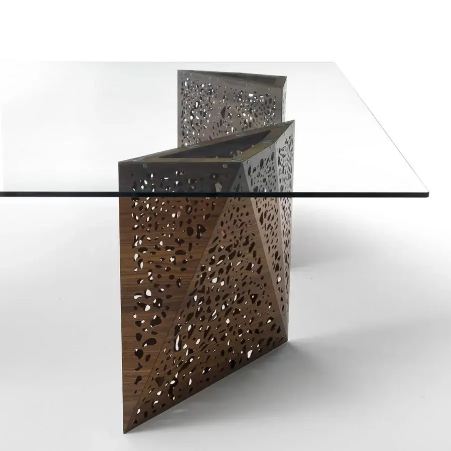 Innovative Horm Riddled table with a rectangular glass top and geometrically shaped dark brown laser-engraved wooden bases allowing light transmission