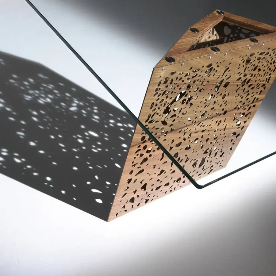 Superior Horm Riddled table with light-toned wood legs inspired by architectural concepts and a rectangular glass top